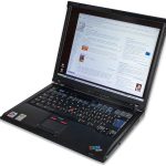 A tablet and laptop sit side by side on a tidy study desk with notebooks.