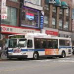 passengers boarding a city bus on a busy street